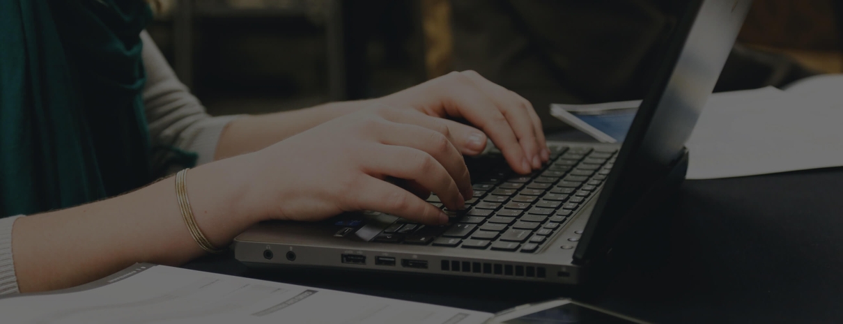 Image of woman typing on a laptop