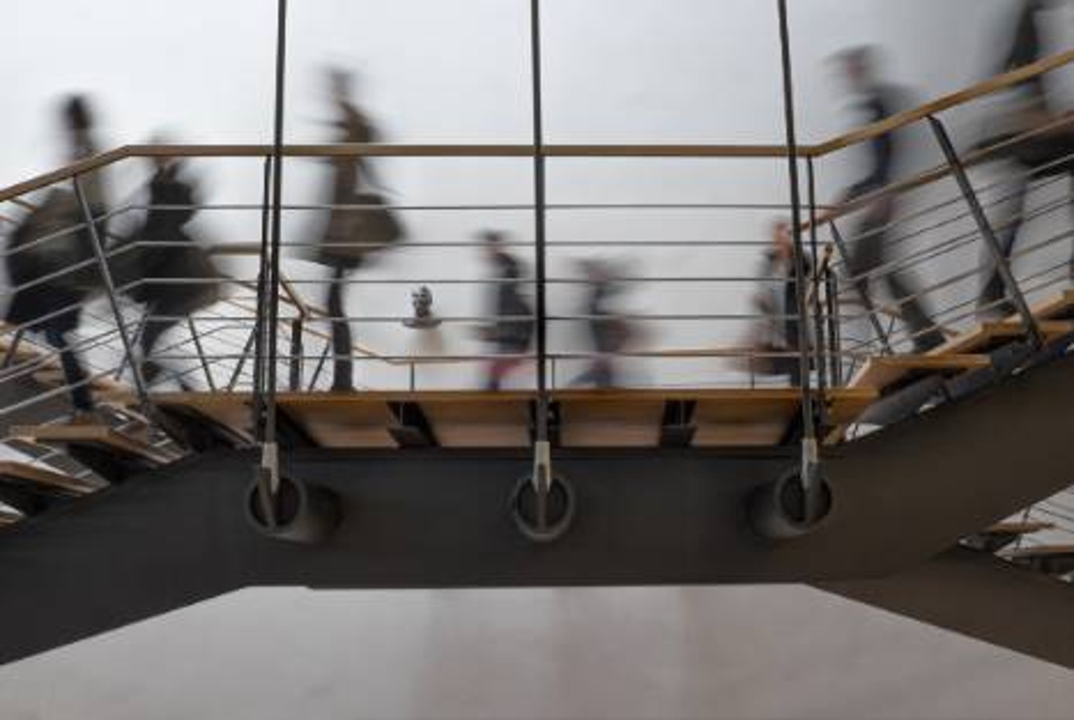 Image of blurry people walking on office stairs